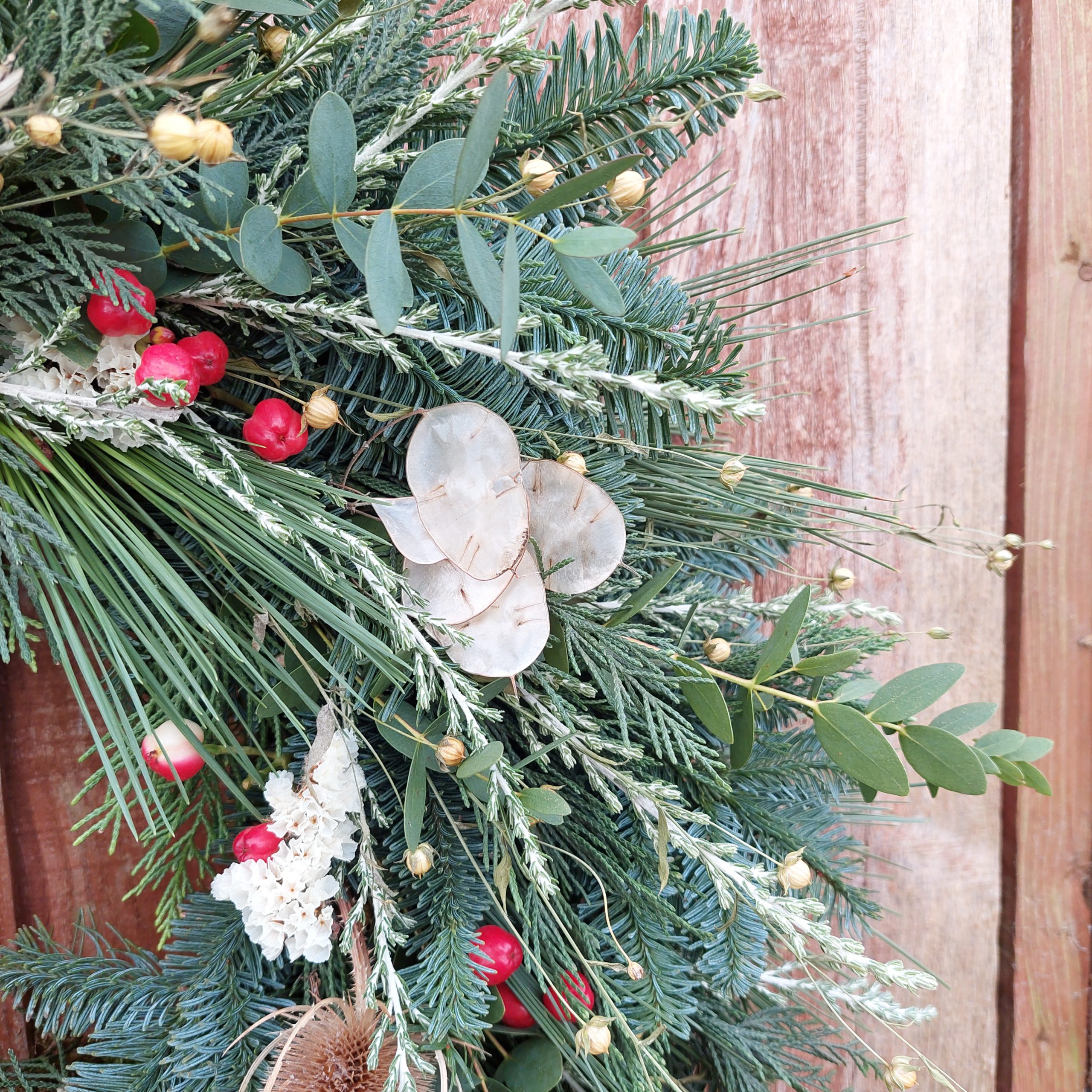 Winter wreath detail white statice, red berries