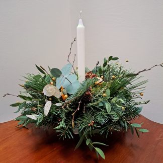 Natural festive table centrepiece with candle